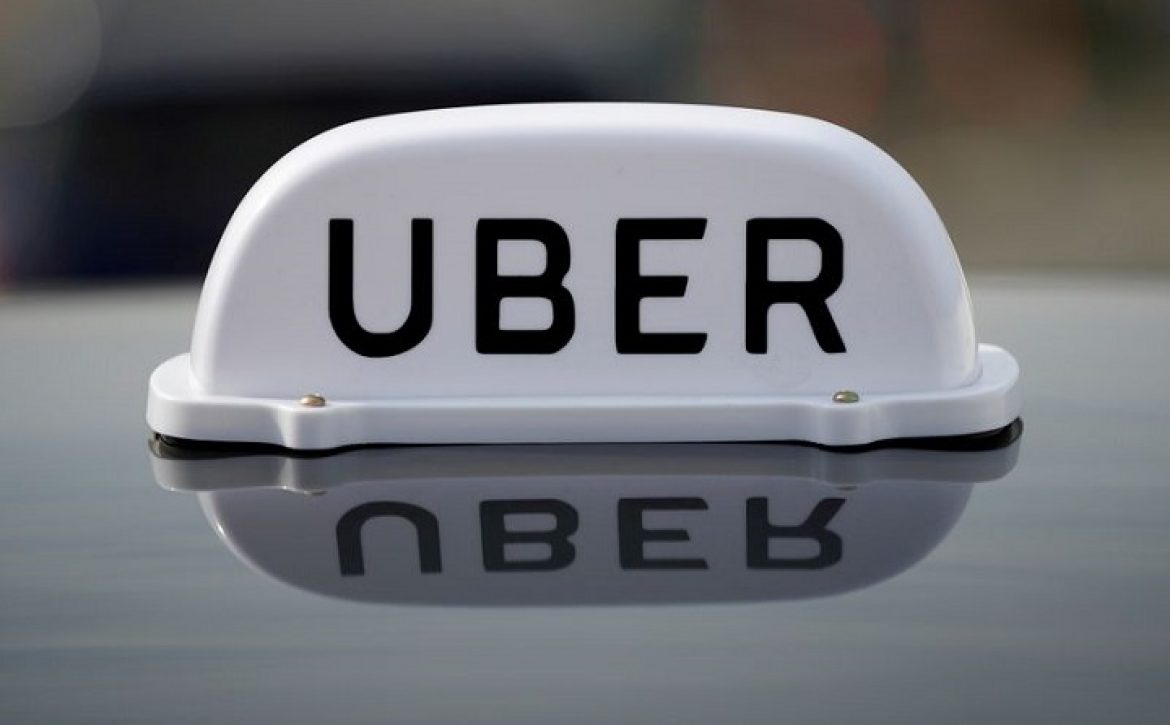 FILE PHOTO: The Logo of taxi company Uber is seen on the roof of a private hire taxi in Liverpool